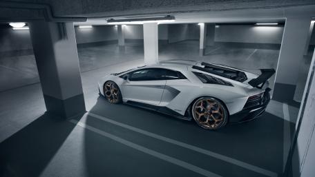 Sleek White Lamborghini in Urban Garage Atmosphere wallpaper