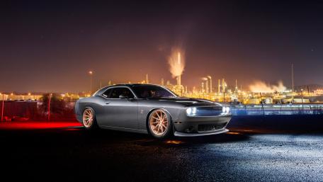 Sleek Muscle Car Against Urban Nightscape wallpaper