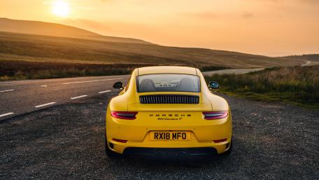 Vibrant Yellow Porsche at Sunset Scenic Drive wallpaper