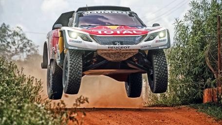 Epic Off-Road Action with Peugeot Racing Vehicle wallpaper