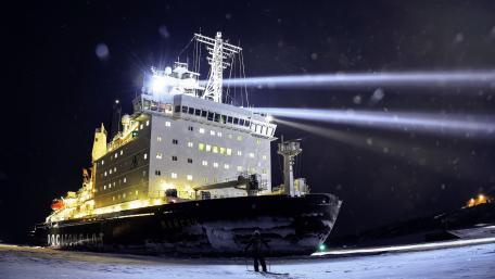 Majestic Icebreaker Navigating Arctic Waters at Night wallpaper