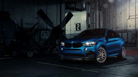 Sleek Blue BMW X6 in Industrial Setting wallpaper