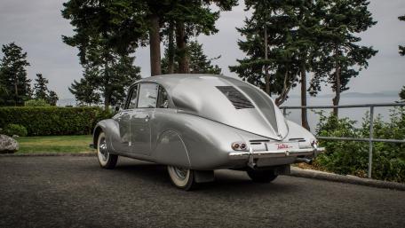 Classic Silver Car with Elegant Curves and Scenic Background wallpaper