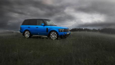 Striking Blue SUV Against Dramatic Skies wallpaper