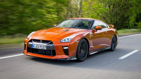 Dynamic Orange Sports Car in Motion wallpaper