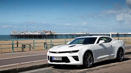 Sleek White Camaro by the Beach Shoreline wallpaper