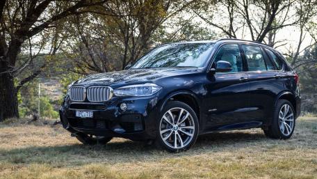 Sleek Luxury SUV in Nature's Embrace wallpaper