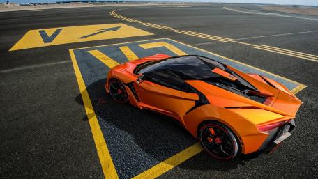Futuristic Orange Supercar on Runway wallpaper