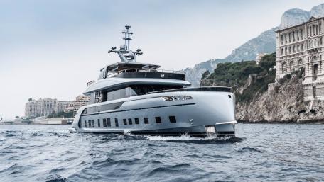 Sleek Yacht Amidst Coastal Elegance wallpaper