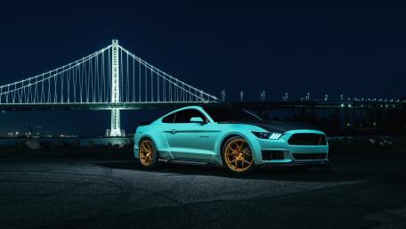 Sleek Mustang Under the San Francisco Skyline Night Lights wallpaper