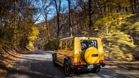 Vibrant Yellow SUV on a Scenic Drive wallpaper