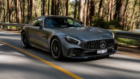 Sleek Mercedes Driving Through Nature's Beauty wallpaper