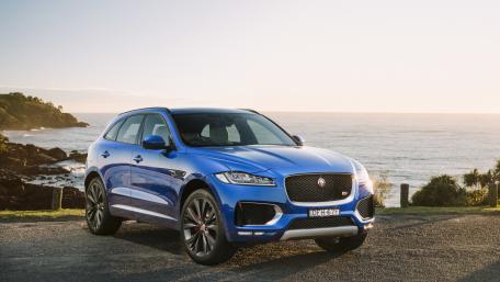 Sleek Blue SUV by the Ocean Shore wallpaper
