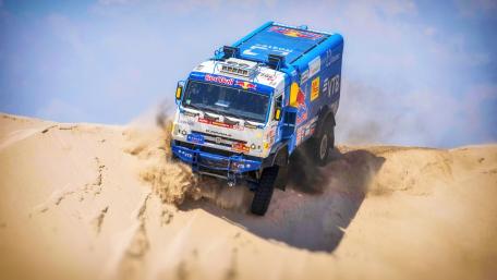 Adventurous Truck Racing Through Desert Dunes wallpaper