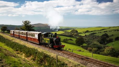 Charming Vintage Locomotive in Scenic Landscape wallpaper
