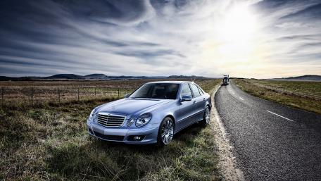 Sleek Silver Car against Scenic Background wallpaper