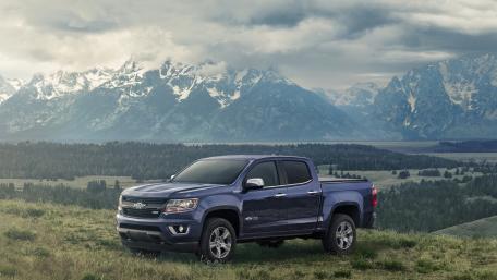 Adventure-Ready Pickup in Majestic Mountains wallpaper