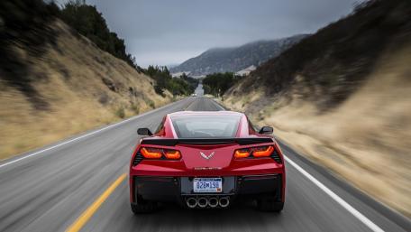 Sleek Red Corvette on Open Road wallpaper