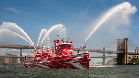 Vibrant Fireboat Displaying Strength and Graceful Power wallpaper