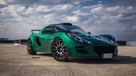 Sleek Green Sports Car on Urban Rooftop wallpaper