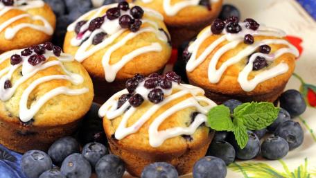 Blueberry Muffins Topped with Creamy Icing and Berries wallpaper