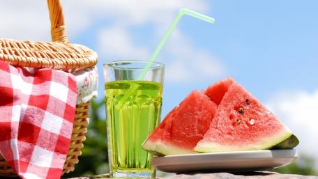 Refreshing Summer Picnic Scene with Watermelon and Drink wallpaper