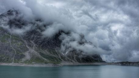 Majestic Clouds Over Serene Lake wallpaper