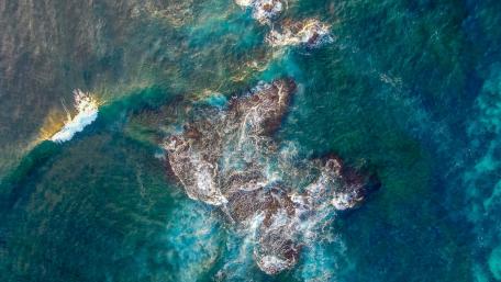 Turquoise Waters Meet Rocky Shores wallpaper
