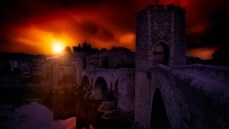 Majestic Sunset Over a Historic Bridge wallpaper