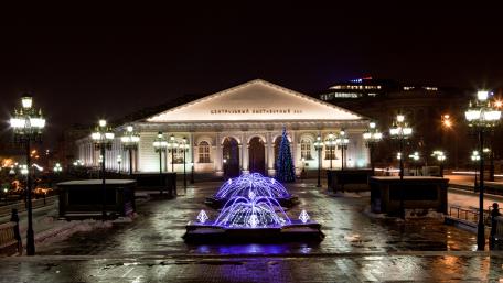 Stunning Night View of a City Square with Fountains and Lights wallpaper