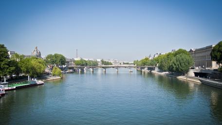 Serene River Scene in a Vibrant Cityscape wallpaper