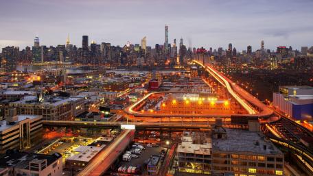 Vibrant Twilight Cityscape Overlooking Urban Skyline and Transportation Routes wallpaper