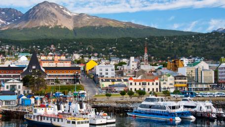 Colorful Waterfront Cityscape with Mountains wallpaper