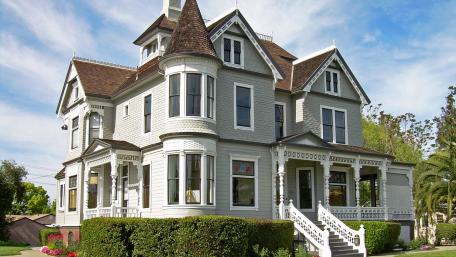 Charming Victorian House in Bright Cityscape wallpaper
