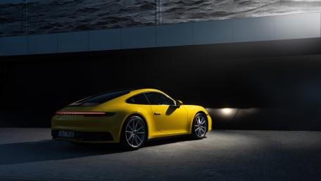 Vibrant Yellow Porsche in Urban Nightscape wallpaper