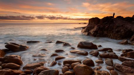 Breathtaking Coastal Sunset Over Tranquil Waves wallpaper