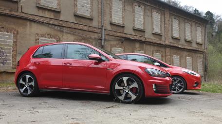 Red Hatchbacks in Urban Setting wallpaper