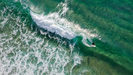Surfer Riding a Wave in the Sea wallpaper