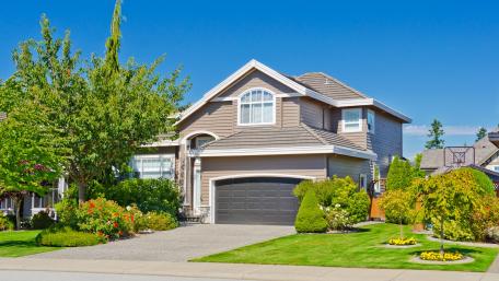 Charming Suburban Home Under Clear Blue Sky wallpaper