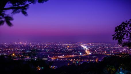 Dusk Over A Gleaming Purple Cityscape wallpaper