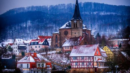 Charming Winter Village Beneath the Church Tower wallpaper