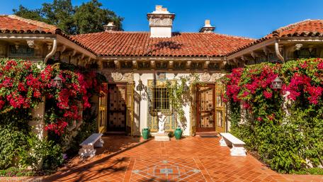 Charming Cottage Surrounded by Vibrant Blooms wallpaper