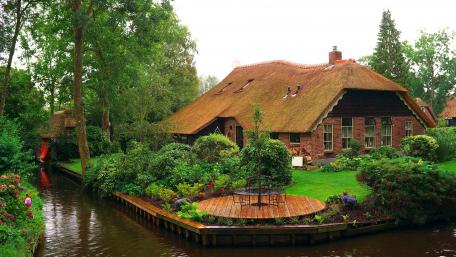 Charming Cottage by Tranquil Waterway wallpaper