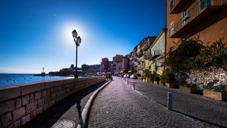 Charming Coastal Street View in Vibrant Cityscape wallpaper