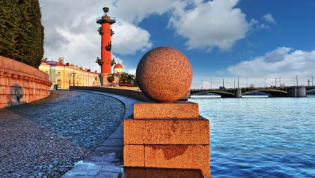 Serene Urban Landscape with Iconic Structures and Water Reflection wallpaper