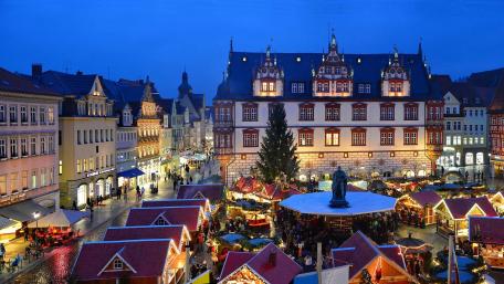 Enchanting Evening Market Scene in a Historic City Square wallpaper