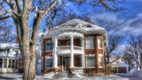 Charming Winter Cottage Surrounded by Snowy Bliss wallpaper