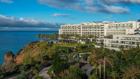 Coastal Paradise with Lush Gardens and Modern Architecture wallpaper