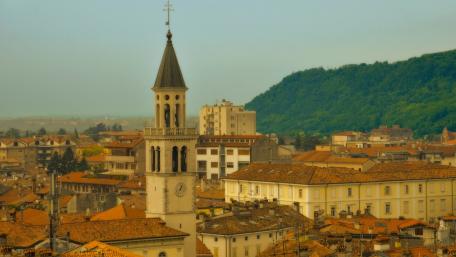 Charming Cityscape with Historic Architecture and Verdant Hills wallpaper