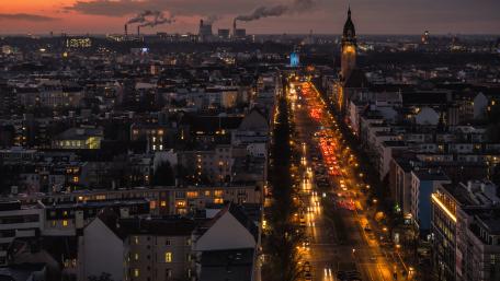 Cityscape at Dusk with Vibrant Lights and Smoke wallpaper